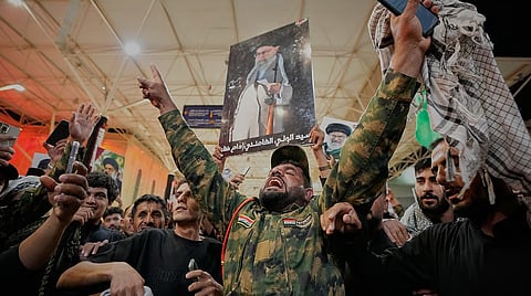 An Iraqi Shiite soldier chants on the eve of funeral ceremonies for the late Iranian Supreme Leader Ayatollah Ali Khamenei outside the Imam Ali Shrine in Najaf, Iraq.