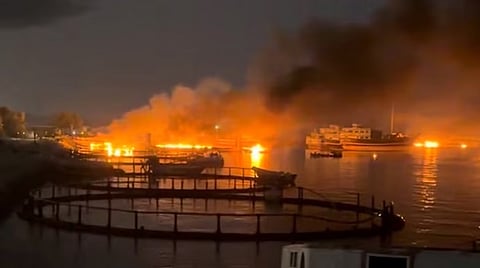 Smoke rises from a port near Strait of Hormuz following US strikes. (Reuters)