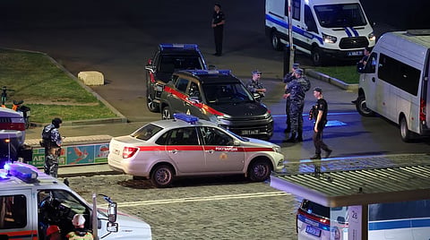 Law enforcement officers and emergency services personnel near the site.