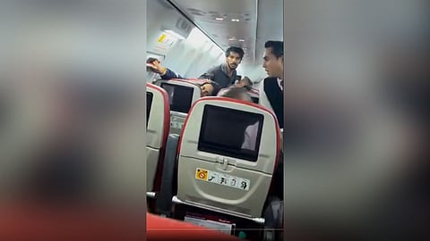 Man tries to force open the emergency exit door
