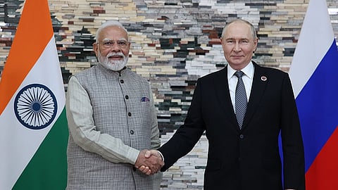 Russian President Vladimir Putin, right, and Prime Minister Narendra Modi pose for a photo during their meeting