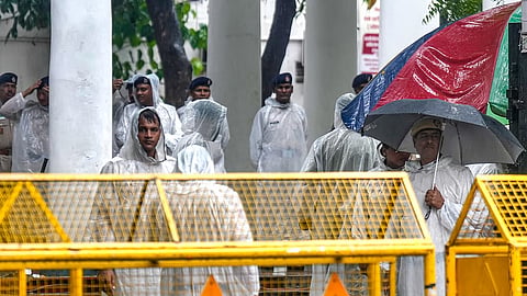 Police personnel stand guard outside Parliament Street police station 