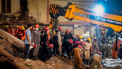 Police, NDRF, fire department officials conduct a rescue operation.