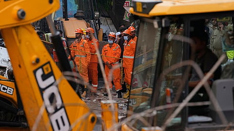 Rescue workers continue to search for people trapped under the debris of a collapsed building in New Delhi, India, Monday, Sept. 7, 2026. 