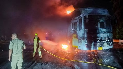 Firefighters at the site after a sleeper bus caught fire on the Yamuna Expressway in the Greater Noida area.