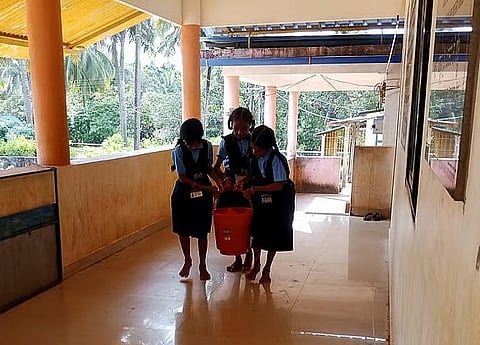 school children brings water from well 