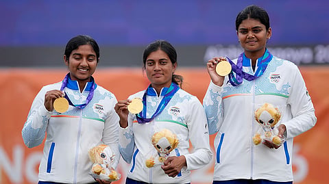 Gold medalist, India team members celebrate on the podium during the medal ceremony