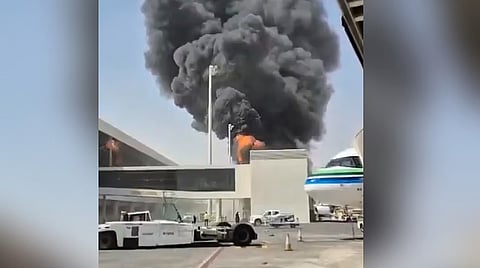 This image from video obtained and verified by AP shows thick black smoke and flames rising from a fire at King Khalid International Airport in Riyadh.