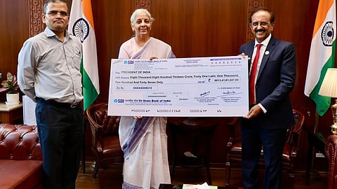 SBI chief hands over ₹8,813 crore cheque to Finance Minister