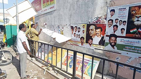 மதுராந்தகம் பகுதியில் சுவரொட்டிகளை அகற்றும் பணியில் ஈடுபட்ட நகராட்சி பணியாளர்கள்.