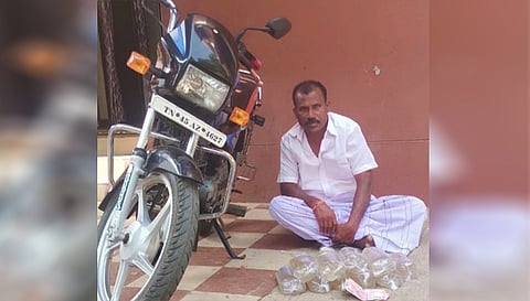 கைது செய்யப்பட்ட சந்திரன் பறிமுதல் செய்யப்பட்ட  பைக், சாராய பாக்கெட்டுகள்.
