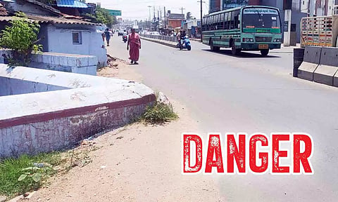 ேபாக்குவரத்துக்கு இடையூறாக இருக்கும் கோவில் சுற்றுச்சுவர்.