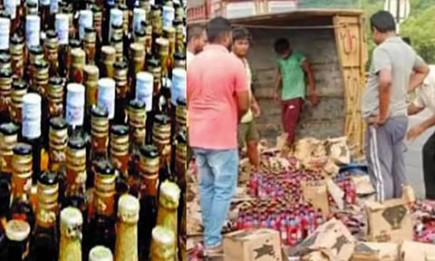 மதுபானம் ஏற்றி வந்த லாரி கவிழ்ந்து விபத்து- மது பாட்டில்களை போட்டி போட்டு அள்ளிச் சென்ற பொதுமக்கள்