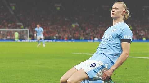 Erling Haaland celebrates after scoring against Manchester United for City.