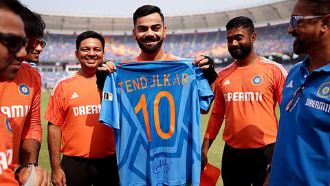 Virat Kohli with the jersey gifted to him by Sachin Tendulkar.