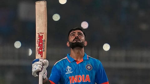 Virat Kohli thanking the heavens after completing his record-equaling ton.