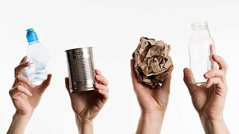 Hands holding waste items, symbolic image