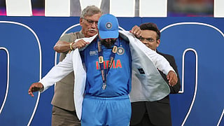 BCCI chief Roger Binny helps Rohit Sharma wear the iconic white jacket after winning the ICC Champions Trophy 2025