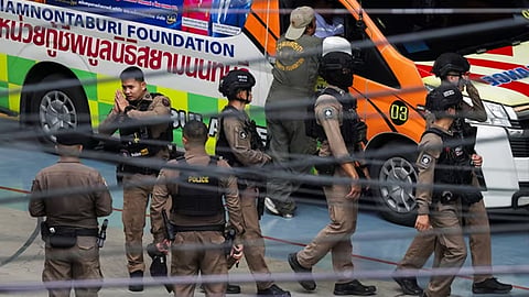 Police stationed in front of the school in Thailand where the shooting took place.