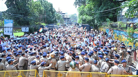 Police are stopping those protesting to demand Gnanesh Kumar's resignation.
