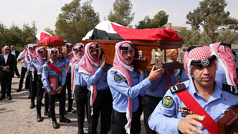 nine men killed in the attack were buried beside the church on Sunday
