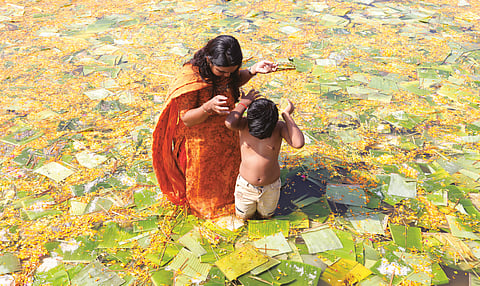 Devotees perform 'Bali Tharpanam' ritual at Aluva Manappuram as part of Mahashivratri on Sunday. 