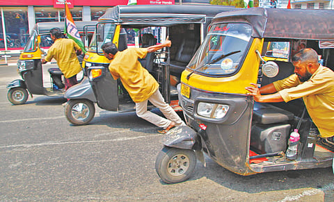 Auto rickshaw drivers pulling their vehicles towards the Secretariat in Thiruvananthapuram on Monday

									- 

