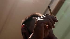 A Japanese tourist smokes cannabis at a Dutch passion shop in Bangkok, Thailand, 