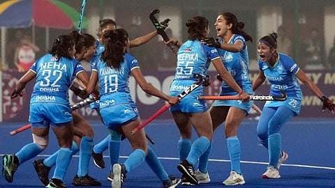 Indian players celebrate a goal against Germany.