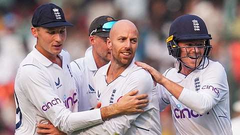 England's Jack Leach celebrates with teammates after taking the wicket of India's captain Rohit Sharma.