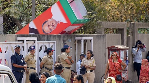 Police personnel guard after a welcome gate in a stampede at a programe organised by the Bharatiya Janta Party in Nagpur, Saturday, March 9, 2024. 
