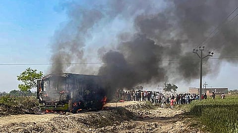 Smoke billows after a bus came in contact with a live wire and caught fire, in Ghazipur district, Monday, March 11, 2024.