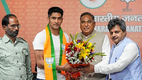 Boxer and former Congress leader Vijender Singh being greeted by BJP leader Ramvir Singh Bidhuri as he joins the party ahead of Lok Sabha elections, at BJP HQ in New Delhi, Wednesday, April 3, 2024.
