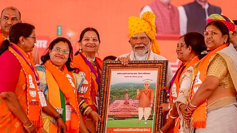 Prime Minister Narendra Modi being felicitated during a public meeting ahead of the second phase of Lok Sabha elections, in Banswara district.