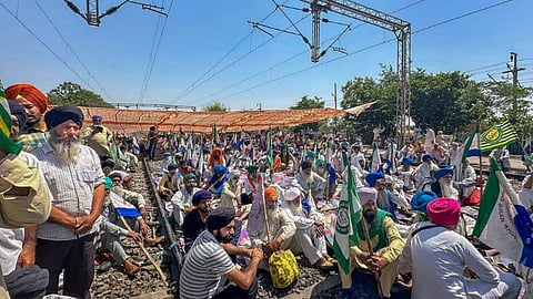 Farmers sit on railway tracks during a protest at the Shambhu border, in Patiala district, Wednesday, April 17, 2024.