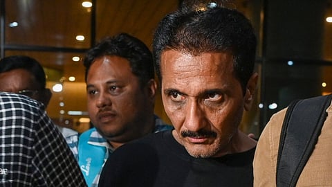 Mumbai Police Crime Branch team brings Bhavesh Bhinde (in black cloth), an accused in the Ghatkopar hoarding collapse case, from Udaipur, at the Mumbai Airport on Thursday late night, May 16, 2024.