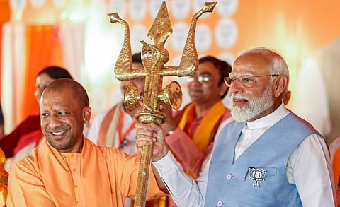 Prime Minister Narendra Modi being presented a trident by Uttar Pradesh Chief Minister Yogi Adityanath during a public meeting for Lok Sabha elections, in Barabanki, Uttar Pradesh, Friday, May 17, 2024.