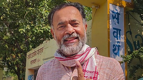 Activist Yogendra Yadav flashes his ink-marked finger after casting his vote for the sixth phase of Lok Sabha elections, in New Delhi, Saturday, May 25, 2024.