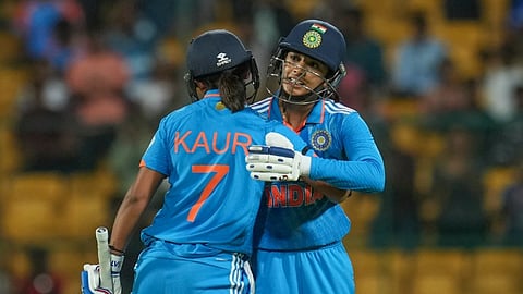 India's batter Smriti Mandhana being congratulated by teammate Harmanpreet Kaur after her dismissal during the third women's ODI cricket match between India and South Africa, at M Chinnaswamy Stadium in Bengaluru, Sunday, June 23, 2024.
