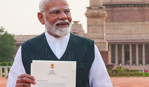 Narendra Modi shows to the media the letter of his appointment as Prime Minister by President Droupadi Murmu after he met her to formally stake claim for government formation, at Rashtrapati Bhavan, in New Delhi, Friday, June 7, 2024. 