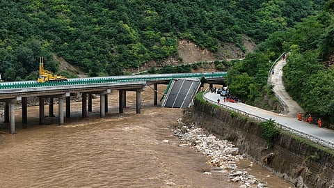 A portion of the bridge on Danning highway in China’s northwestern Shaanxi province lies submerged after collapsing on Friday night.