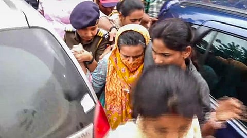 Manorama Khedkar, mother of IAS probationer Puja Khedkar, being brought by the police to a hospital for medical examination after her arrest in a case of allegedly threatening some persons by brandishing a gun over a land dispute, in Pune district, Thursday, July 18, 2024.