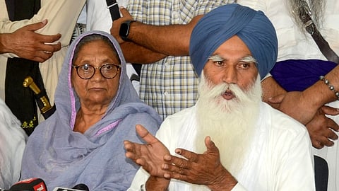 Tarsem Singh, father of radical Sikh preacher and independent MP Amritpal Singh, addresses a press conference. Amritpal's mother Balwinder Kaur is also seen.