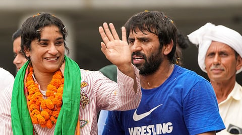 Wrestler Vinesh Phogat with Bajrang Punia being welcomed on her arrival after Paris Olympics heartbreak, at IGI airport, in New Delhi, Saturday, Aug. 17, 2024. 