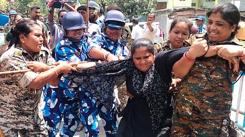 Police personnel detain an agitator during BJP's 12-hour general strike in Bengal (Bangla Bandh) to protest the police action against participants of Tuesday's "Nabanna Abhiyan" rally which was held against the Kolkata R.G.Kar incident, in Cooch Behar district, Wednesday, Aug. 28, 2024. 
