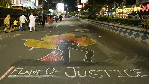 A graffiti is seen on a road amid protests against the alleged rape and murder of a trainee woman doctor at the RG Kar Medical College and Hospital, in Kolkata, Wednesday, Sept. 4, 2024.