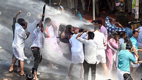 Police use water cannons to disperse Youth Congress activists during their protest demanding the resignation of Kerala Chief Minister Pinarayi Vijayan over LDF MLA P V Anvar's allegations against top IPS officers in the state, Thiruvananthapuram, Thursday, Sept. 5, 2024.