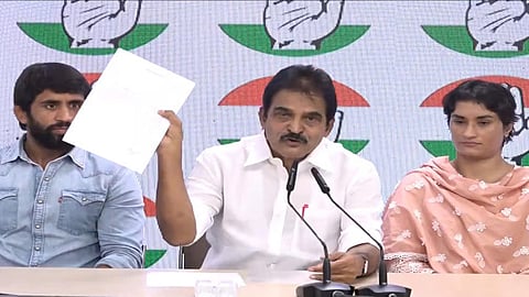 Congress leader KC Venugopal shows the notice served to Wrestler Vinesh Phogat