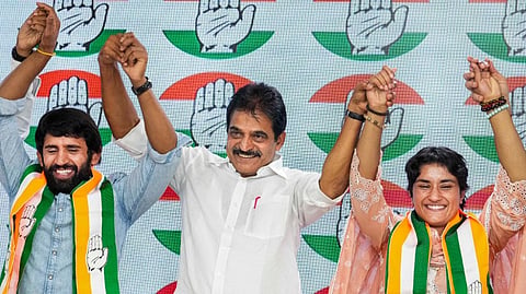 AICC General Secretary KC Venugopal with wrestlers Vinesh Phogat and Bajrang Punia during a press conference after joining the Congress party at the party headquarters, in New Delhi, Friday, Sept. 6, 2024.