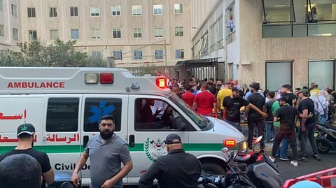 People gather outside the American University hospital after the arrival of several men who were wounded by exploded handheld pagers, in Beirut, Lebanon, Tuesday, Sept. 17, 2024. 